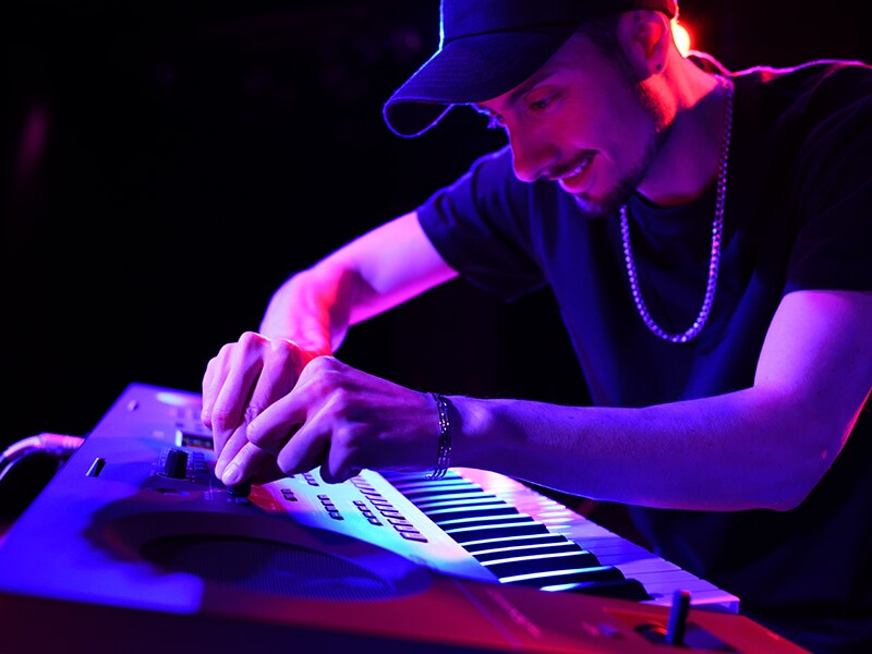 Pemain menyesuaikan Kenop Live Control pada PSR-SX620 selama live performance.